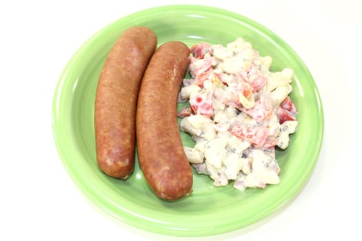 Mettenden with pasta salad against a white background
