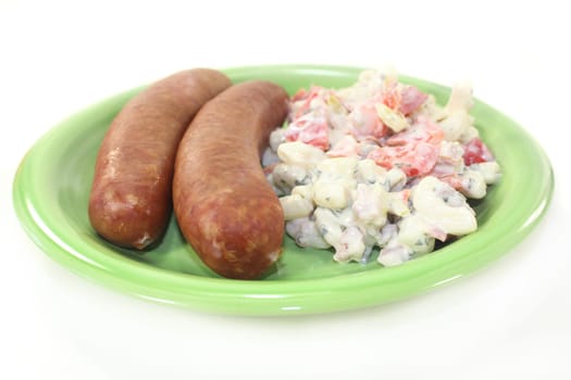 Mettenden with pasta salad against a white background