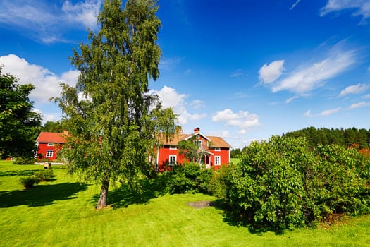 old 17th century red cottages set in a rural landscape, scenery from Sweden