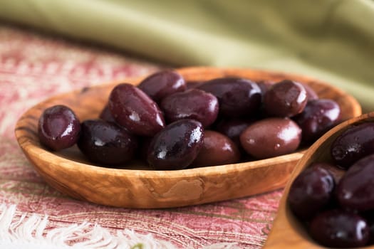 Kalamata olives in a small wooden bowl
