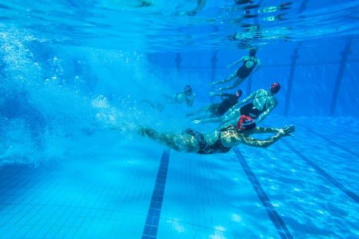 Girls Synchronized underwater swimming water action at national championships
