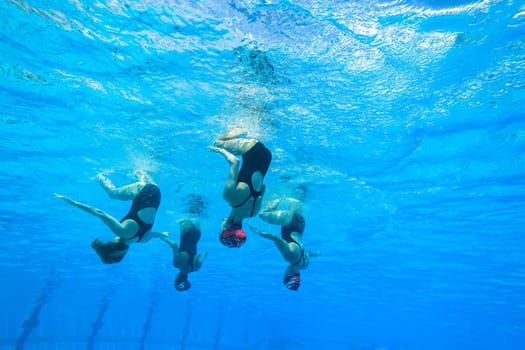 Girls Synchronized underwater swimming water action at national championships