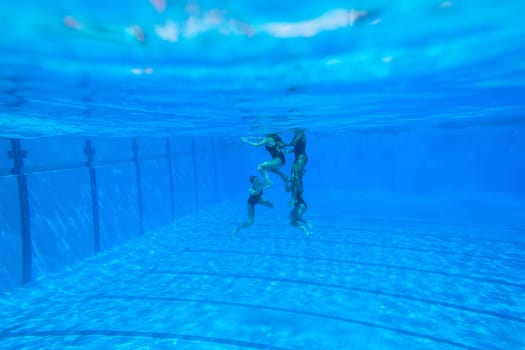 Girls Synchronized underwater swimming water action at national championships