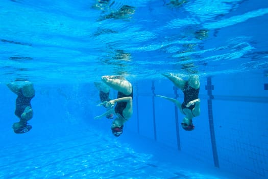 Girls Synchronized underwater swimming water action at national championships