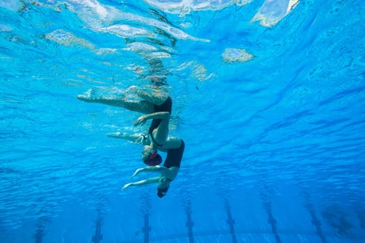 Girls Synchronized underwater swimming water action at national championships