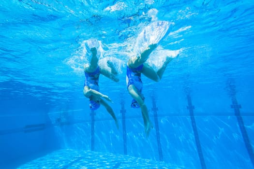 Girls Synchronized underwater swimming water action at national championships