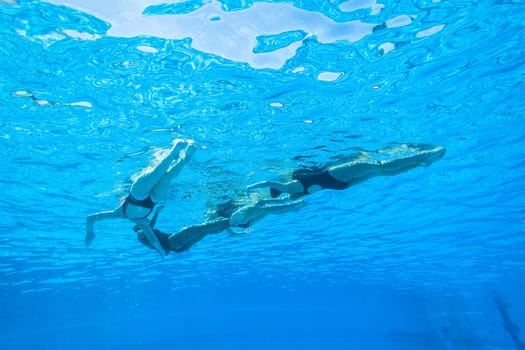 Girls Synchronized underwater swimming water action at national championships