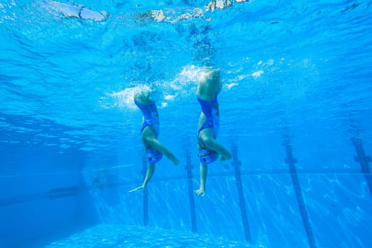 Girls Synchronized underwater swimming water action at national championships