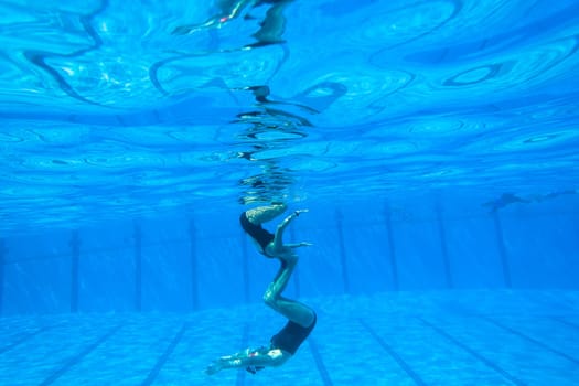 Girls Synchronized underwater swimming water action at national championships