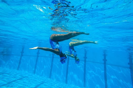 Girls Synchronized underwater swimming water action at national championships