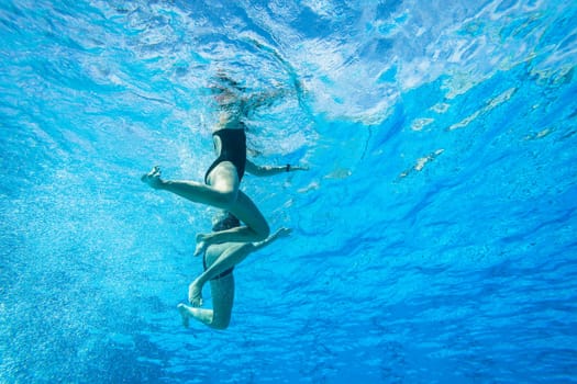 Girls Synchronized underwater swimming water action at national championships