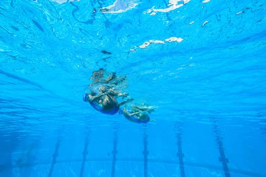 Girls Synchronized underwater swimming water action at national championships