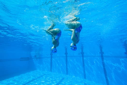 Girls Synchronized underwater swimming water action at national championships