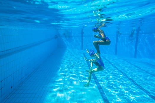 Girls Synchronized underwater swimming water action at national championships