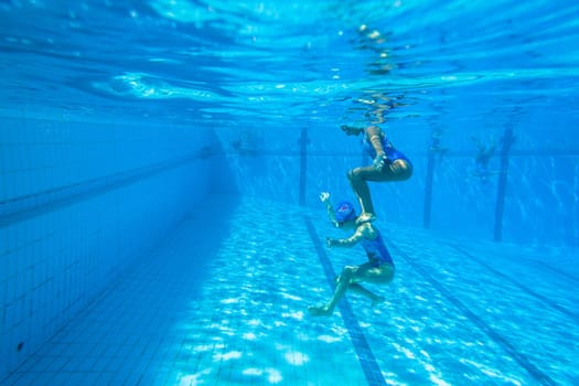 Girls Synchronized underwater swimming water action at national championships