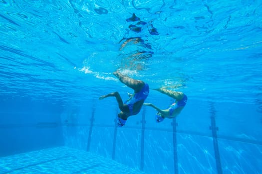 Girls Synchronized underwater swimming water action at national championships
