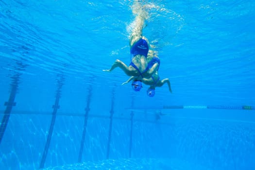Girls Synchronized underwater swimming water action at national championships