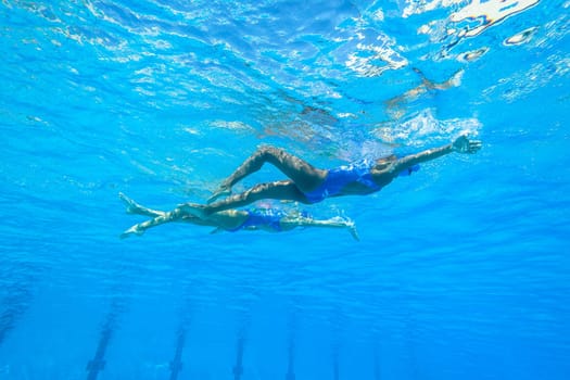 Girls Synchronized underwater swimming water action at national championships