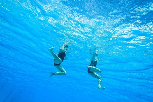 Girls Synchronized underwater swimming water action at national championships