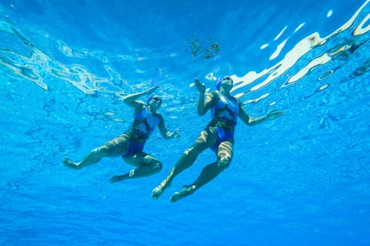 Girls Synchronized underwater swimming water action at national championships
