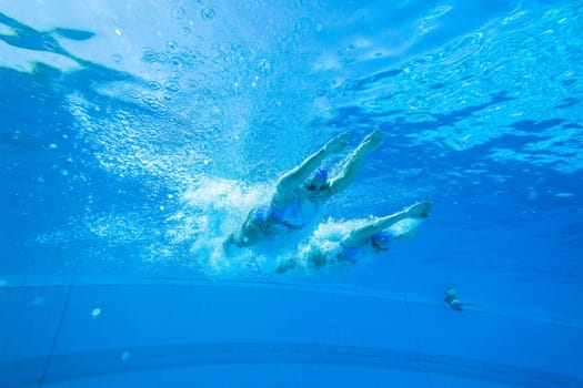 Girls Synchronized underwater swimming water action at national championships