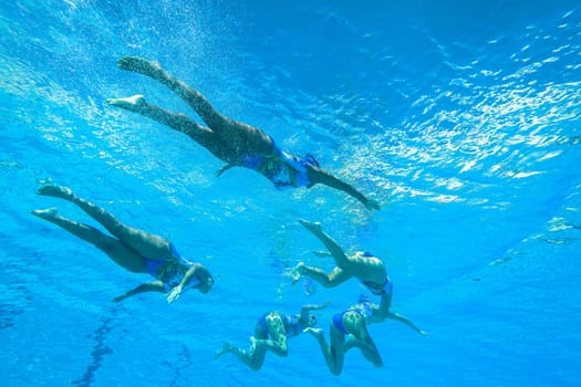 Girls Synchronized underwater swimming water action at national championships