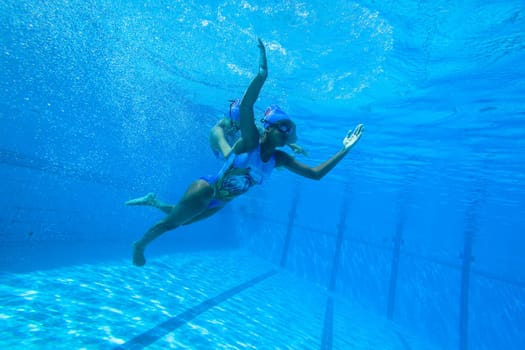 Girls Synchronized underwater swimming water action at national championships