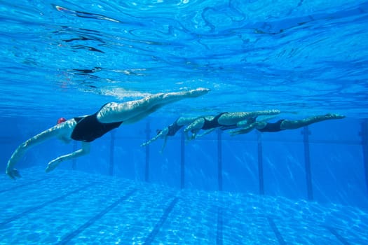 Girls Synchronized underwater swimming water action at national championships