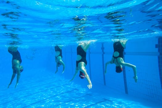 Girls Synchronized underwater swimming water action at national championships