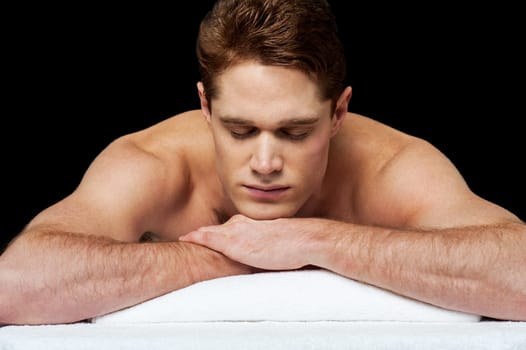 Man relaxing on a massage bed at spa
