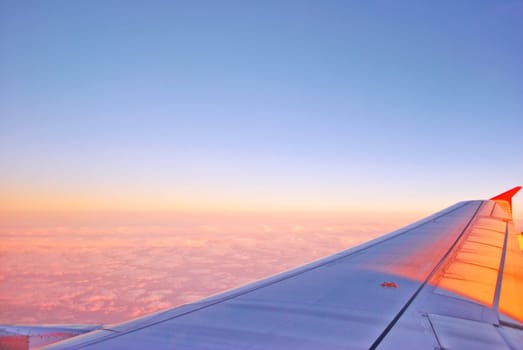 Airplane Flying above the Clouds