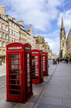 Fragment of old town centre in Edinburgh, capital of Scotland, with characteristic buildings, and red telephon kiosk.