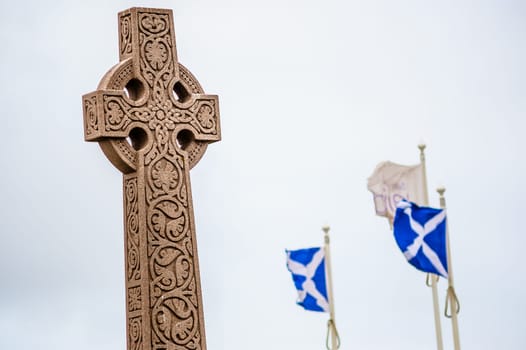 Old style celtic cross with visible national flags of Scotland - St Andrew's Cross Saltire.