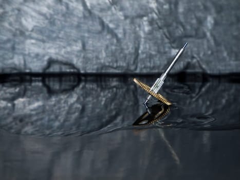 Close-up three fast-rotating gears on water-covered slate slab