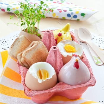 Cooked breakfast eggs with salt,pepper and small toast