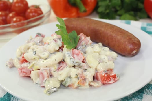 Mettenden with pasta salad against a white background