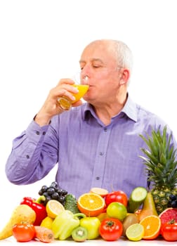 Mature man juice and standing next to fruits and vegetables isolated on white
