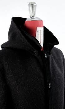 Woolen black coat, inserts and lining in velvet. Detachable hood.