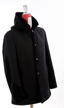 Woolen black coat, inserts and lining in velvet. Detachable hood.