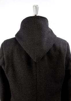 Woolen black coat, inserts and lining in velvet. Detachable hood.