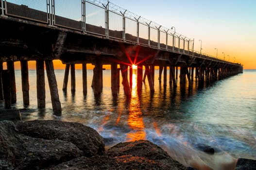 Pont Thermal Badalona, sunrise with the sun between columns