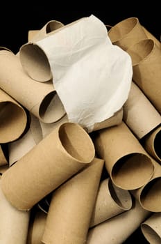 Empty Toilet Rolls Stack Up On a Black Background