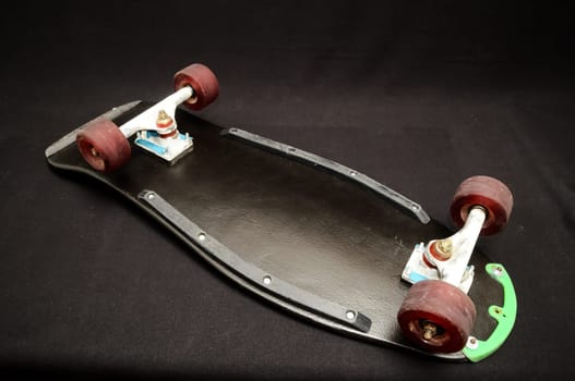 Vintage Style Black Skateboard on a Dark Background