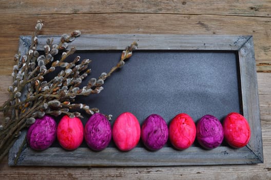 colorful Easter eggs wooden background