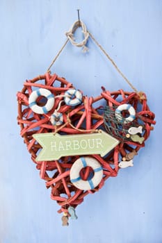 Decorative signpost to the harbour on a blue background made of wood