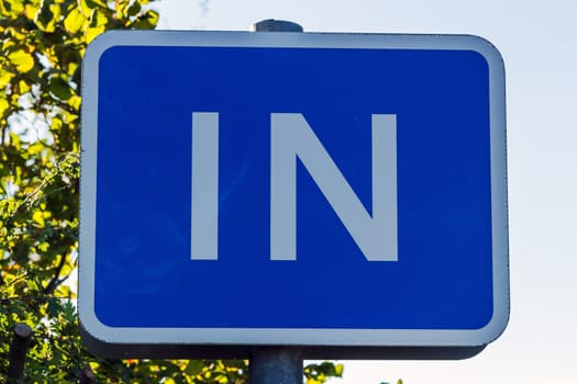 Blue sign indicating an entrance to traffic