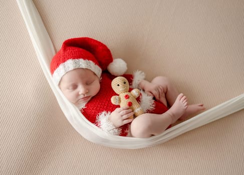 Newborn baby boy wearing Santa Christmas costume. Little infant child New Year xmas portrait