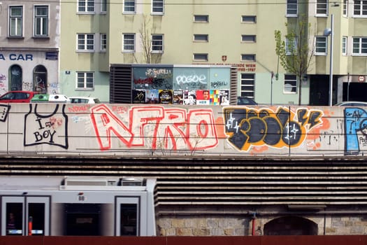 Vienna,Austria - April 01,2014: A tram passes graffiti art in a trendy district on April 1,2014 in Vienna.