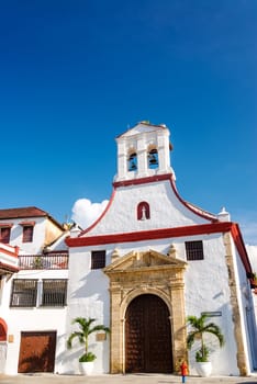 Facade of a white colonial church in the historic center of Cartagena, Colombia
