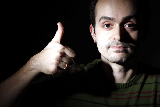 Portrait of a young man, isolated on black background